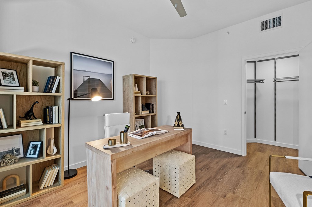 A room with a wooden desk and bookshelf.