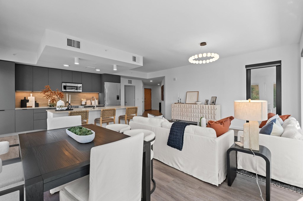 A modern living room with a dining table and a couch.