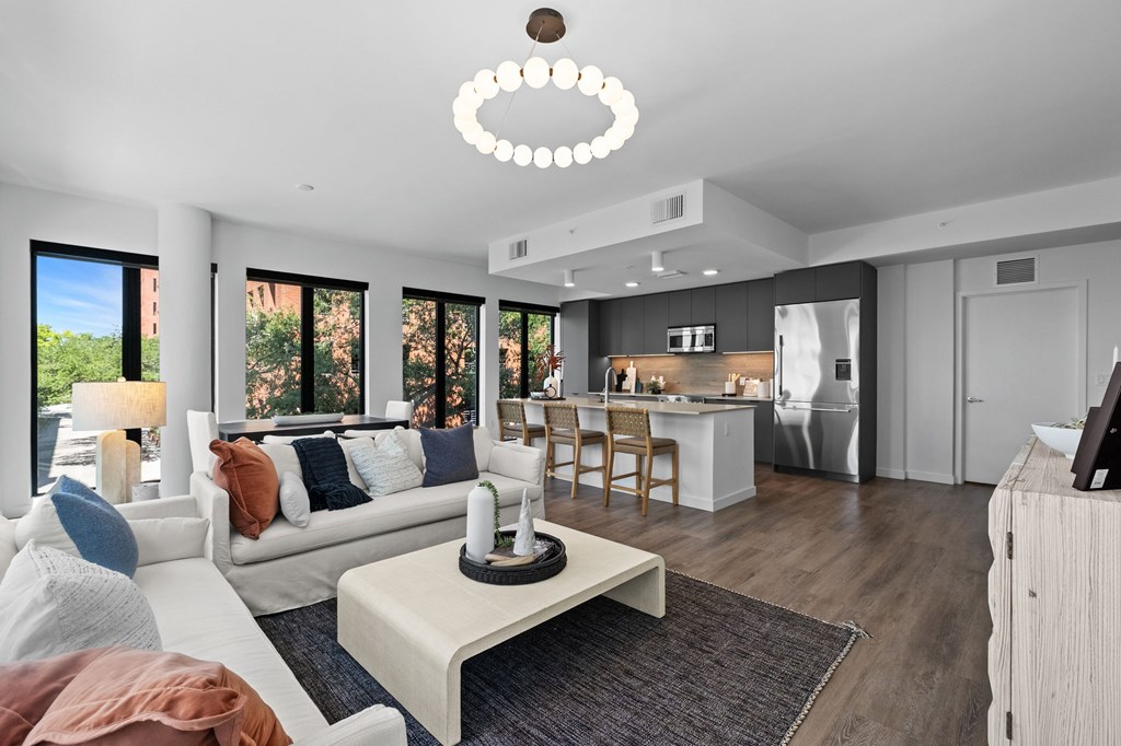 A modern living room with a white sofa and a wooden coffee table.