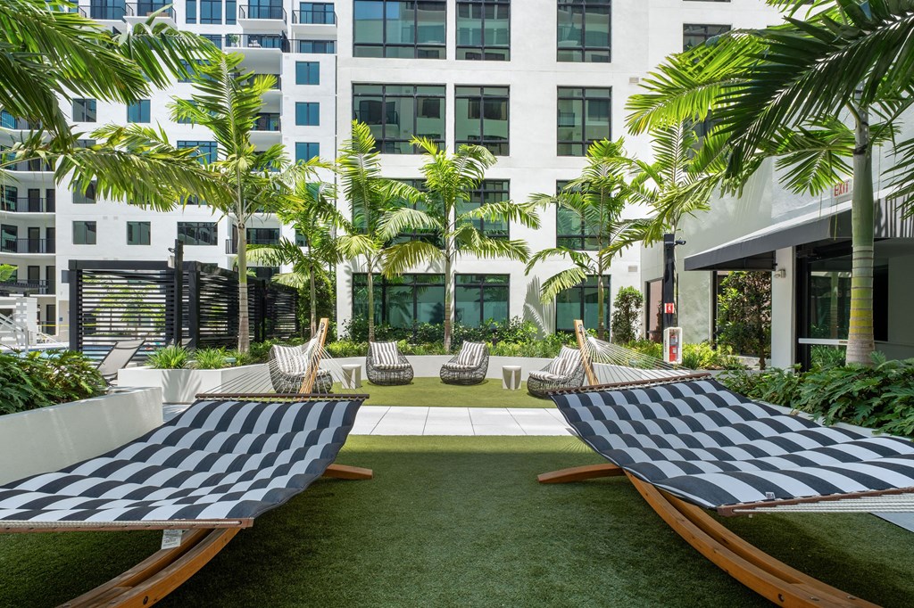 Two chess boards are placed on a lawn.
