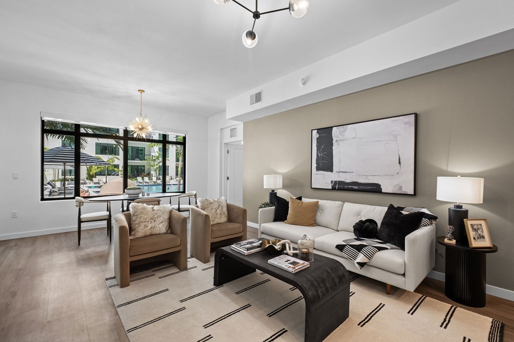 A modern living room with a large window and a white couch.