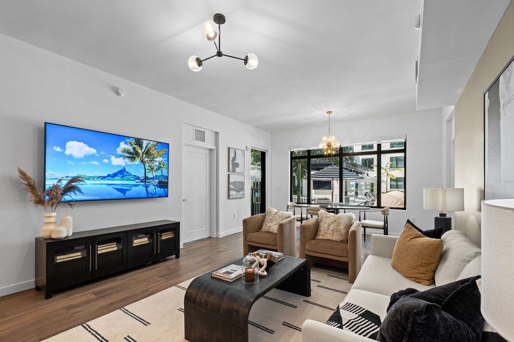 A modern living room with a flat screen TV and comfortable seating.