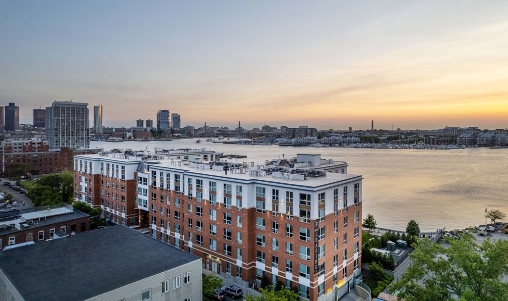 an aerial view of a large building next to a body of water