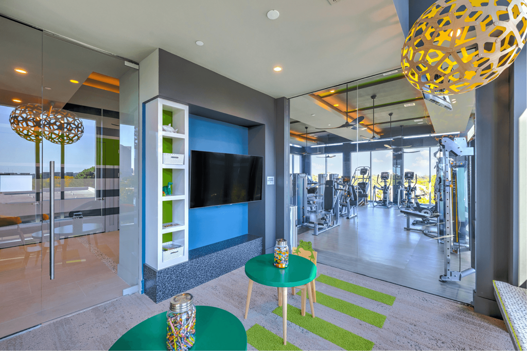 A modern living room with a green table and a television.