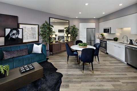A modern kitchen with a dining table set for four.