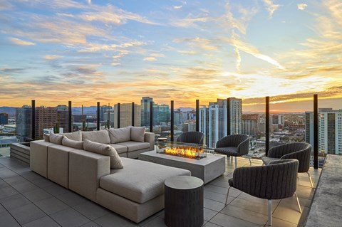 Outdoor lounge space with seating, gas fire pit