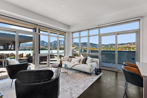 A living room with a view of the mountains.