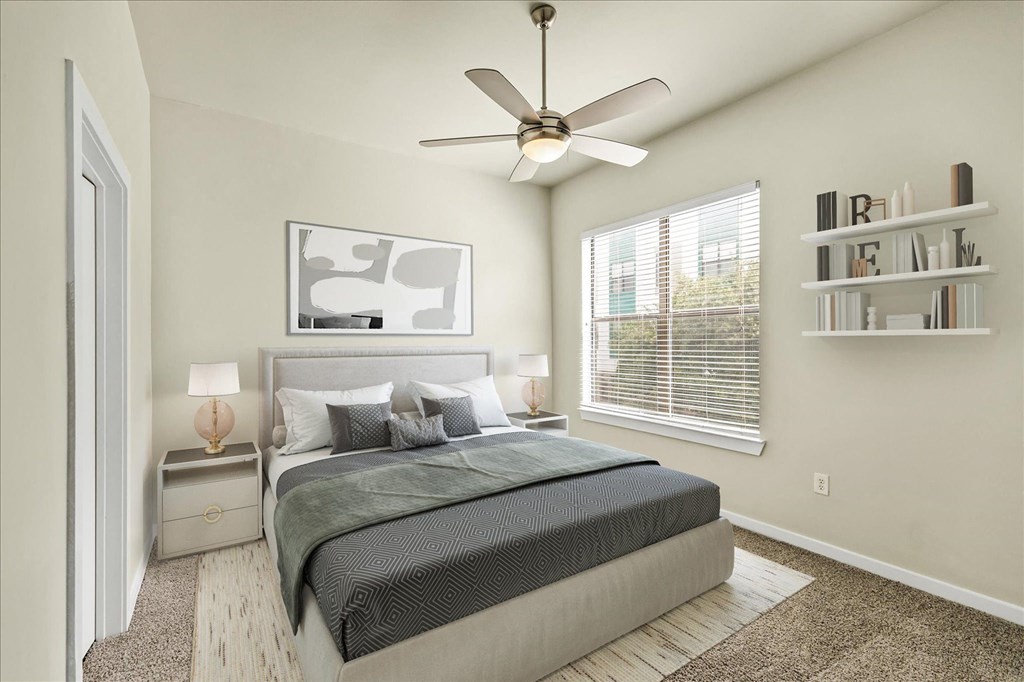 a bedroom with a large bed and a ceiling fan