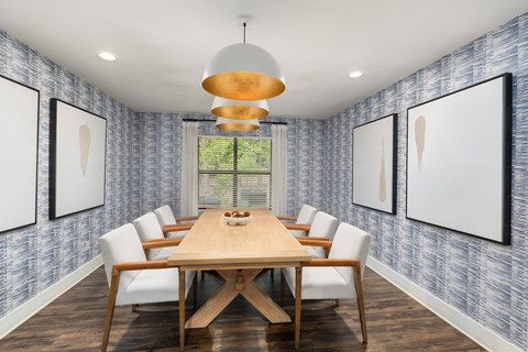 A dining room with a wooden table and chairs.