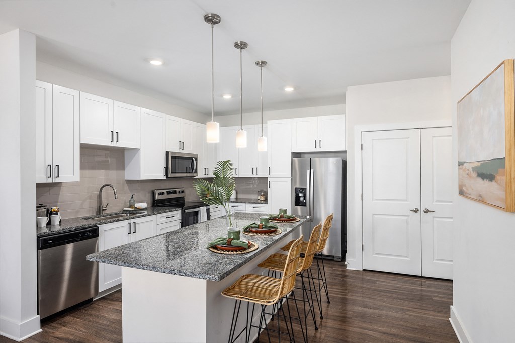 a kitchen with stainless steel appliances and a granite counter top