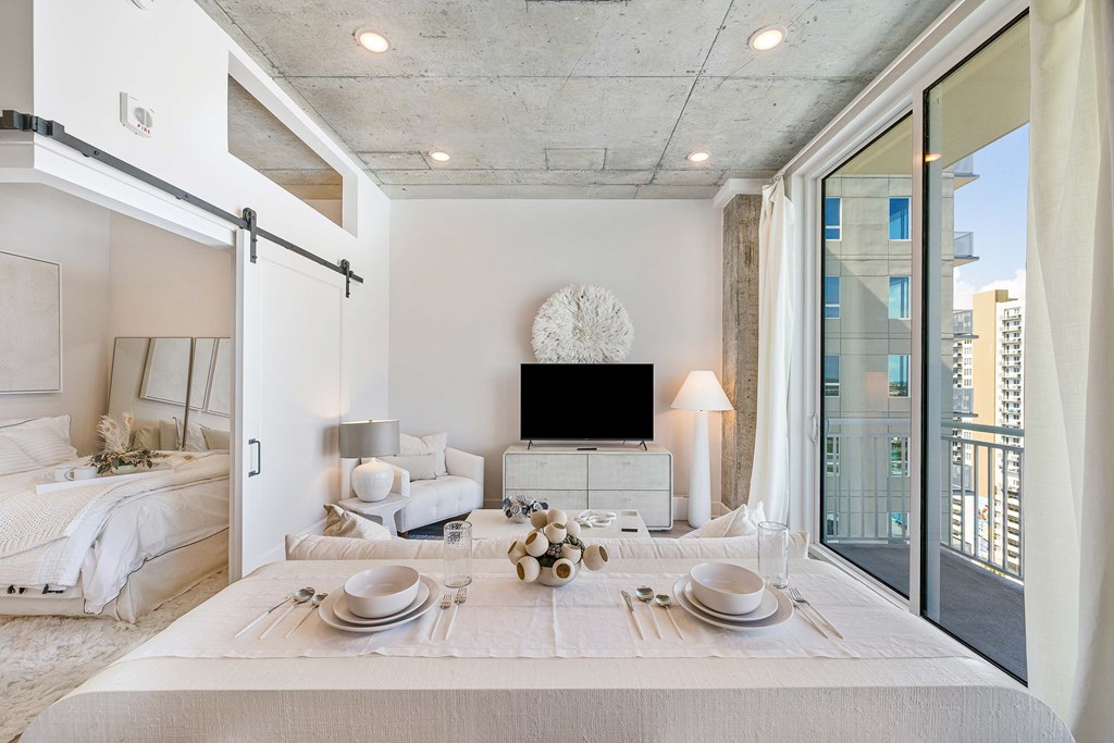 a living room with a bed and a tv