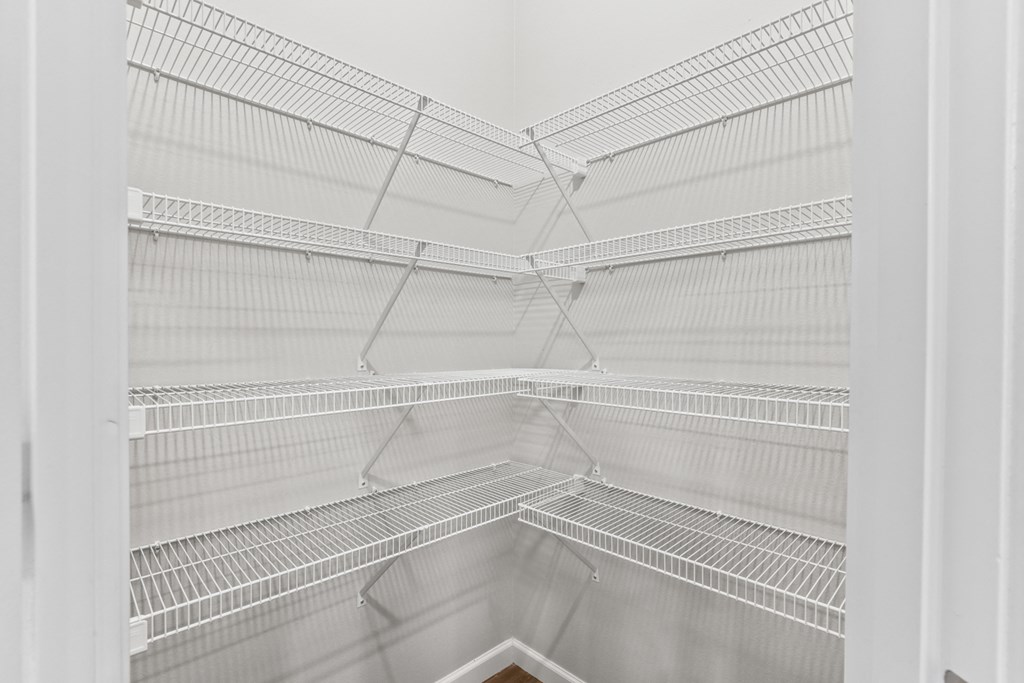 a large empty white refrigerator in a white room