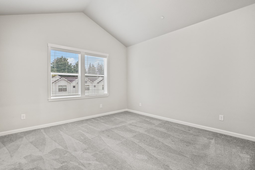 an empty room with a window and concrete floors