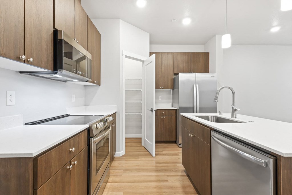 a kitchen with wooden cabinets and stainless steel appliances