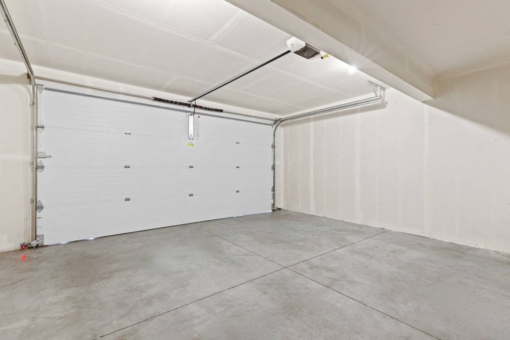 the interior of a garage with a white wall and a garage door