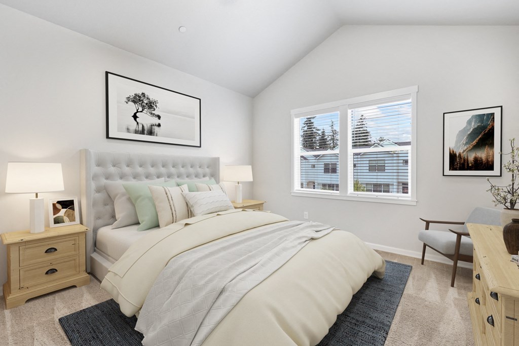 a bedroom with a large bed and two windows