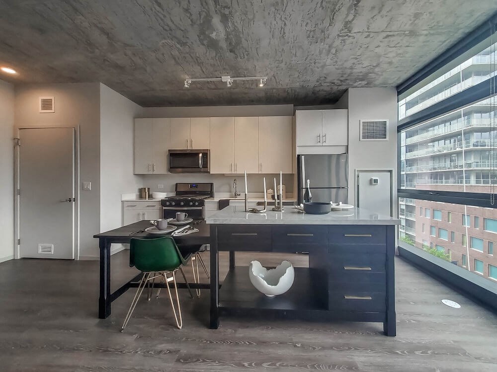 a kitchen with an island and a large window