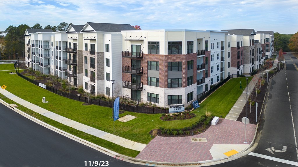 an aerial view of an apartment building on a city street