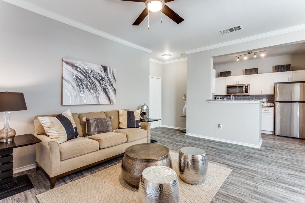 a living room with a couch and a ceiling fan