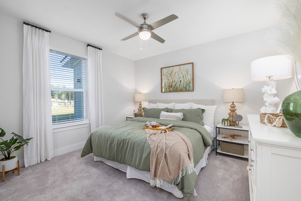 a bedroom with a bed and a ceiling fan