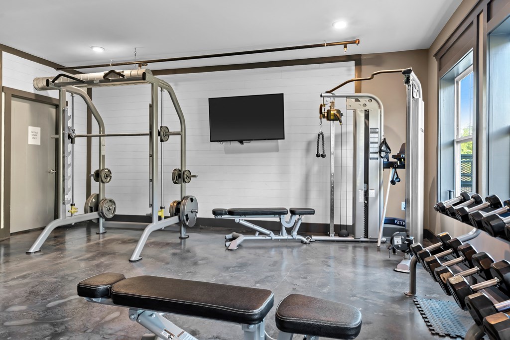Fitness center with various pieces of equipment and weights