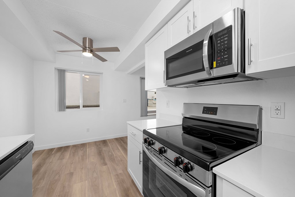 A modern kitchen with a stainless steel oven and microwave.