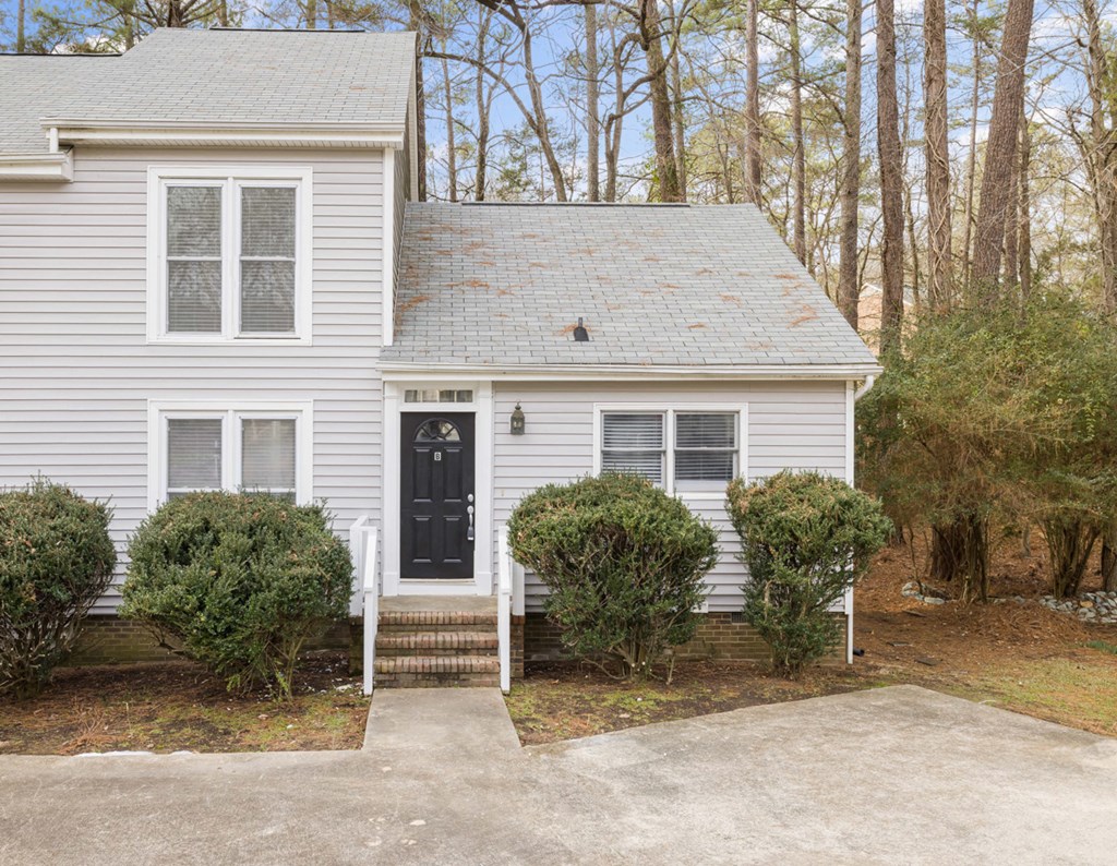 Front of townhome with stairs leading to front door