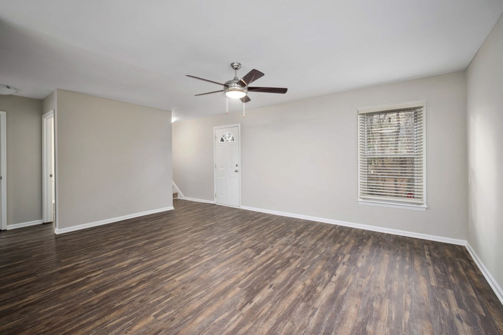 spacious living room with plank flooring, window and plank flooring