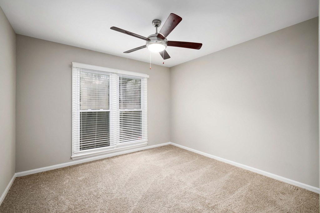 bedroom with large picture window and ceiling fan