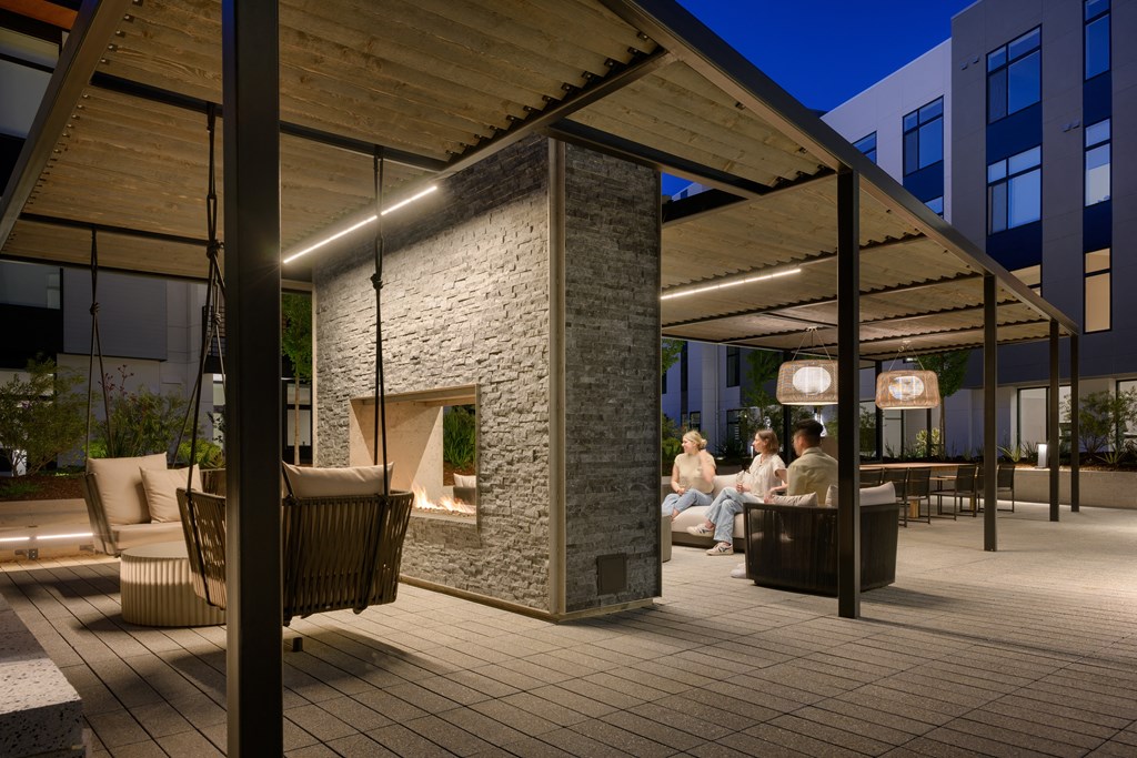 a rendering of a patio with furniture and a fireplace