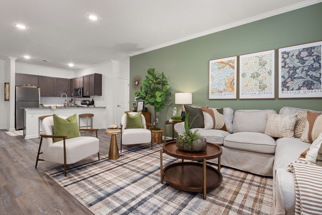 A living room with a couch, chairs, and a coffee table.