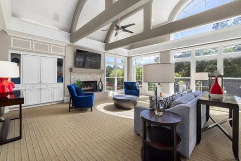 A living room with a grey couch and a blue chair.