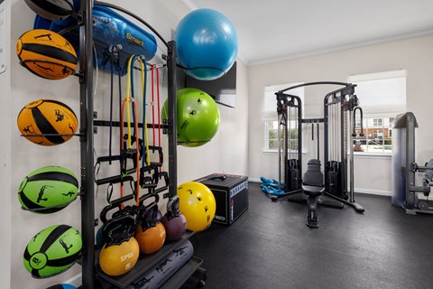 the fitness center with weights and a window