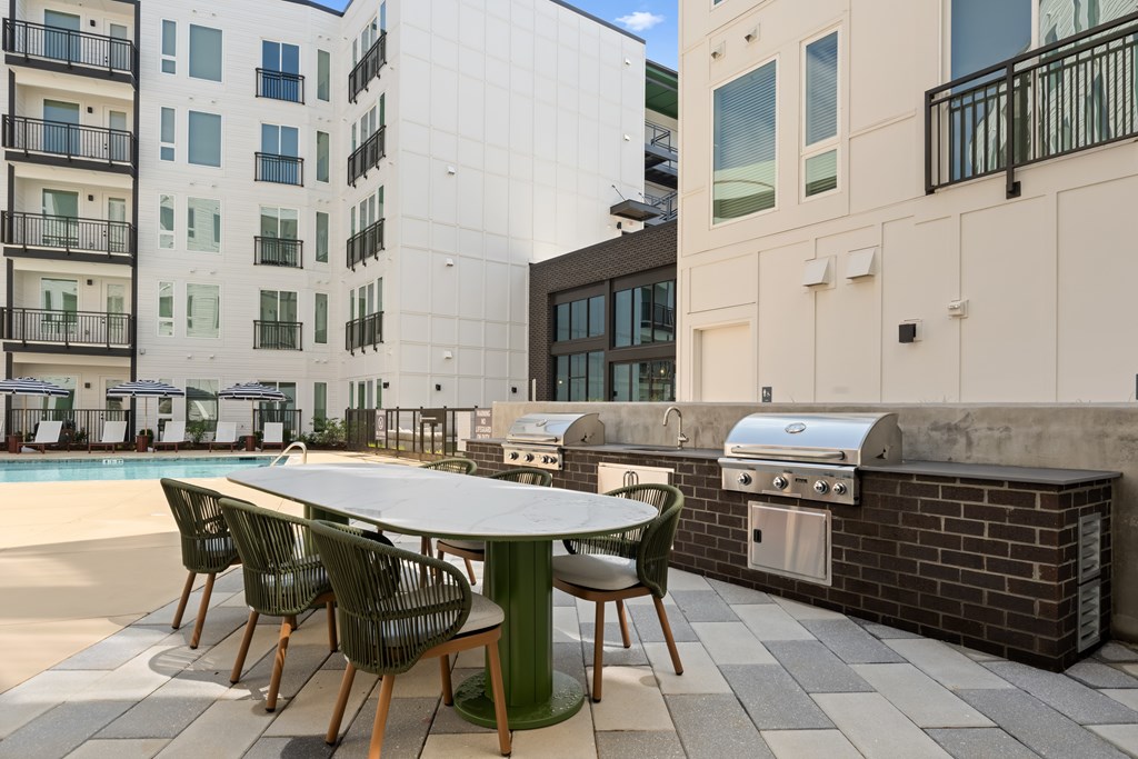 A table with chairs is set up on a patio.