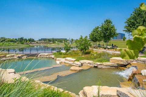 a city with a pond and waterfalls
