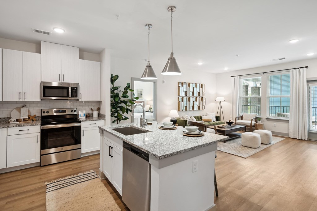 an open kitchen and living room with a large island