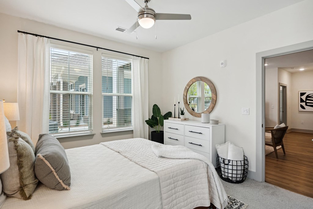 a bedroom with a bed and a large window