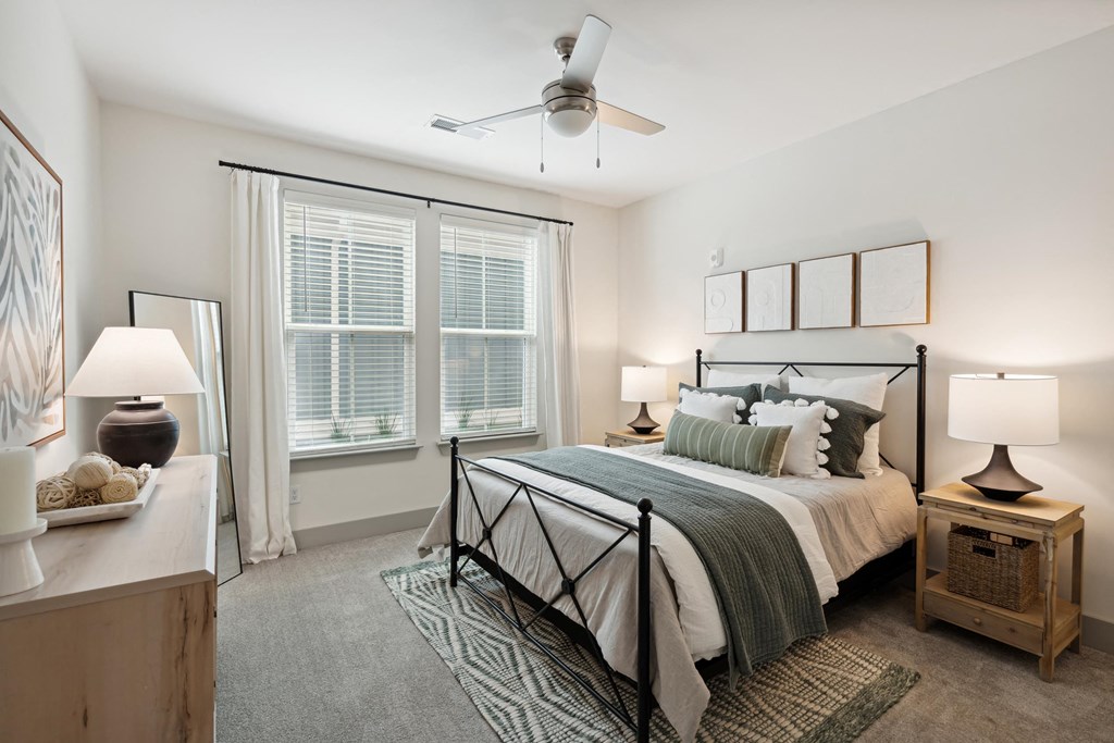 a bedroom with a bed and a ceiling fan