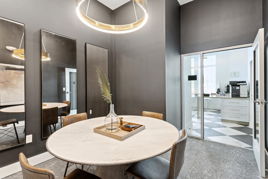 a dining room with a round table and chairs