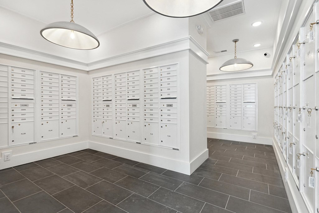 a locker room with white lockers and two lights