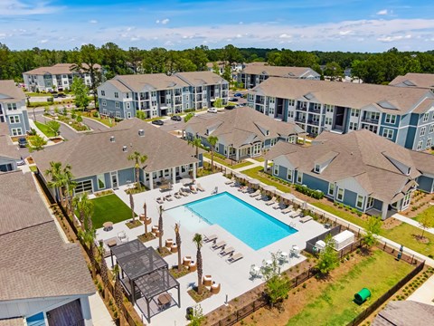 an aerial view of an apartment complex with a swimming pool