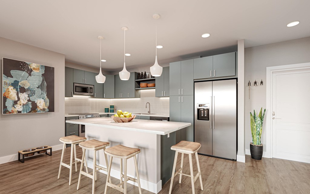 a kitchen with gray cabinets and a white island with three stools