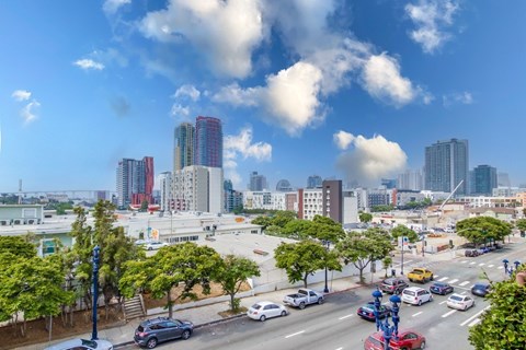 A city street with cars and buildings in the background.