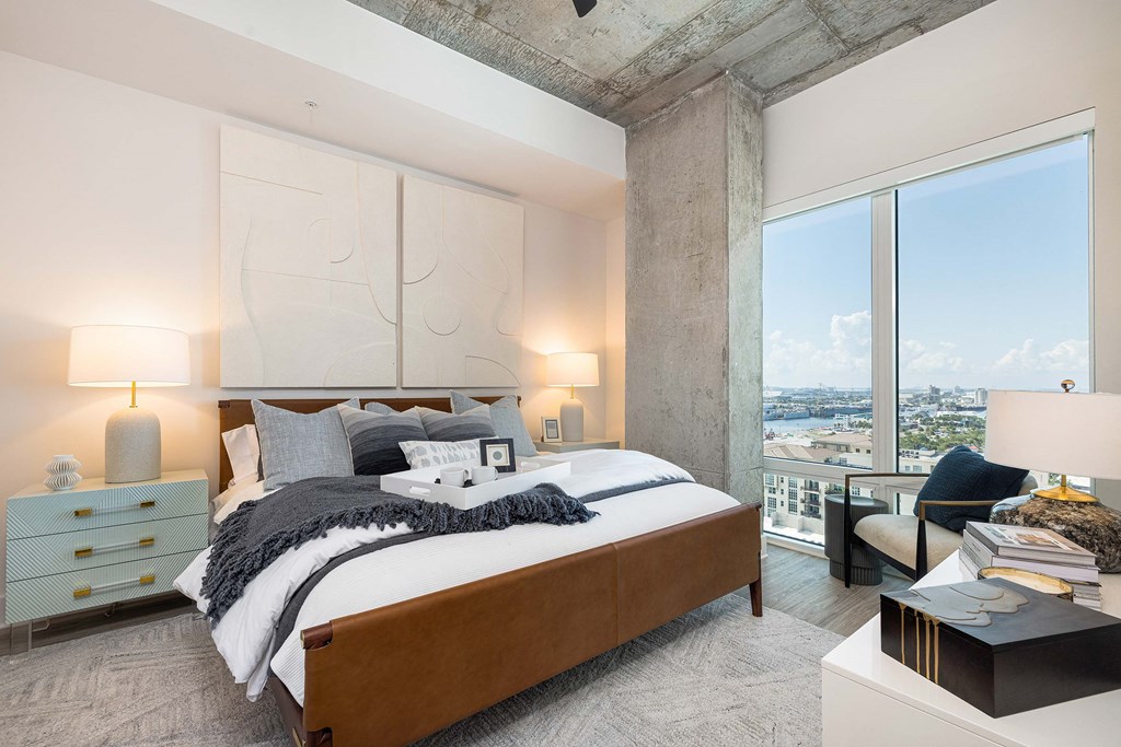 a bedroom with a bed and a large window