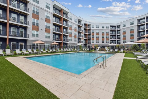 a swimming pool in front of an apartment building