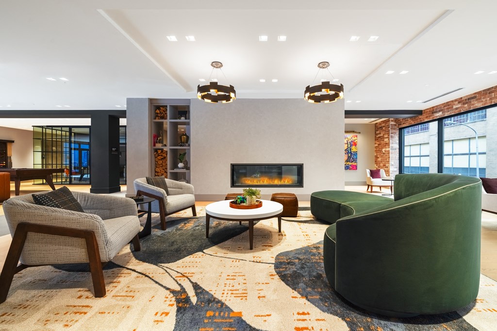 a living room with green furniture and a fireplace