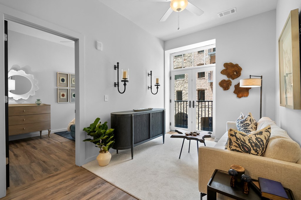 a living room with a door that leads to a bedroom