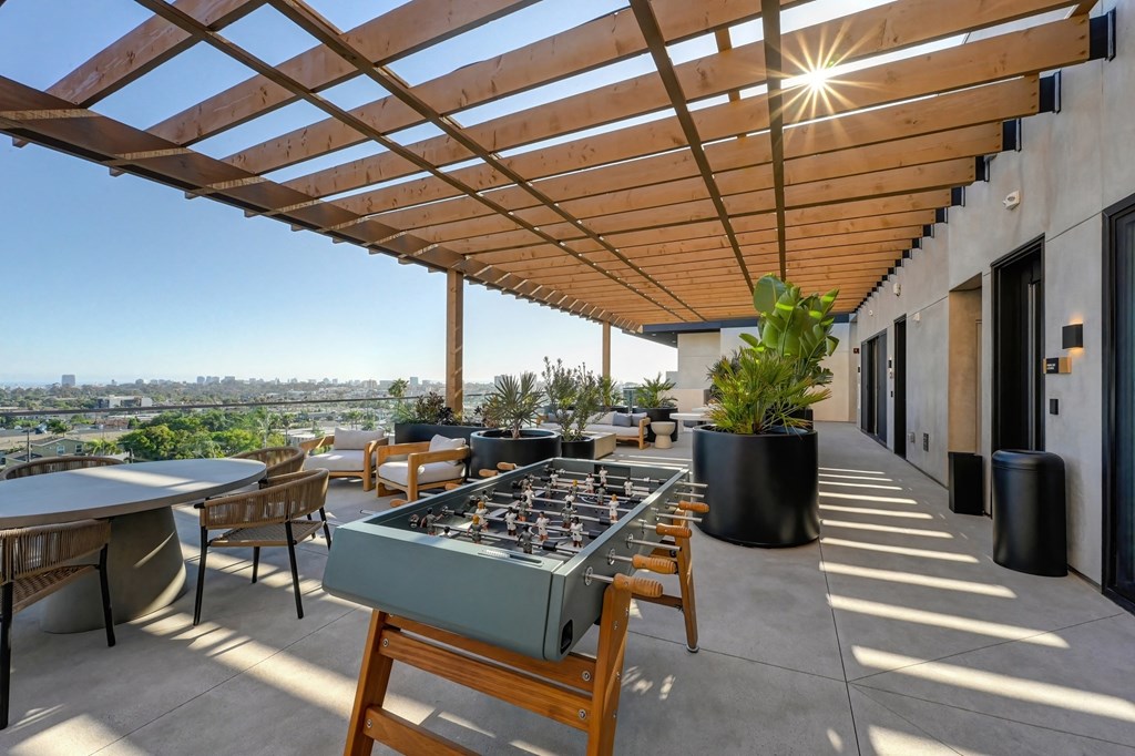 a patio with tables and chairs and a pergola