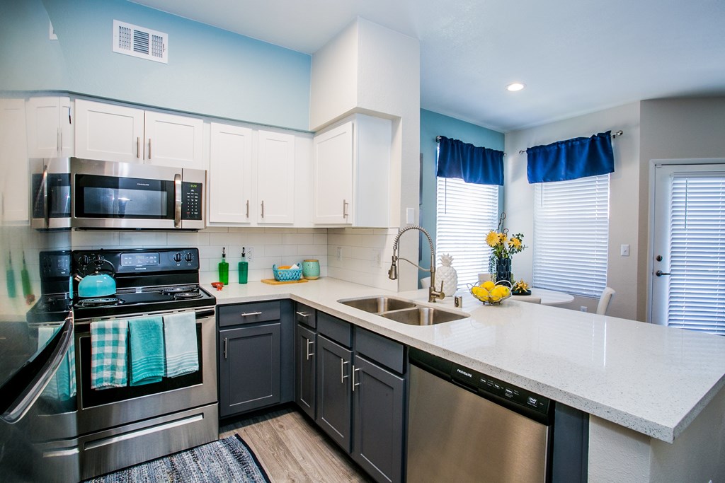A kitchen with a stove, oven, microwave, and dishwasher.