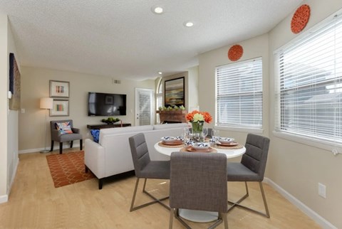 A dining room with a table set for four.